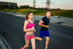 Close-up portrait of athletic couple running photo