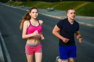 Close-up portrait of athletic couple running photo