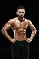 Muscular bodybuilder guy doing posing photo