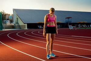 Runner sprinting towards success on run path running athletic track. Goal achievement concept. photo