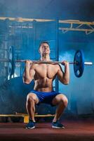 man doing exercises with barbell photo