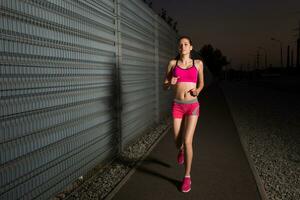 Running woman. Runner jogging in evening. photo