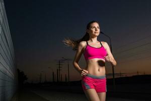 Running woman. Runner jogging in evening. photo