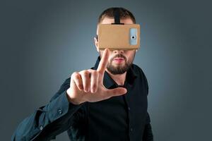 young man using a VR headset glasses photo