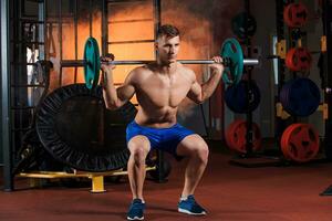 man doing exercises with barbell photo