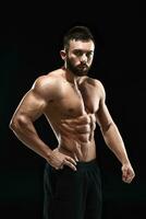 Muscular bodybuilder guy doing posing photo