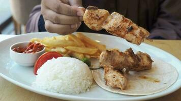 Chicken skewers with french fries and rice video