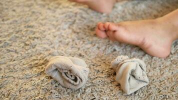 child dirty sock and feet on a carpet video