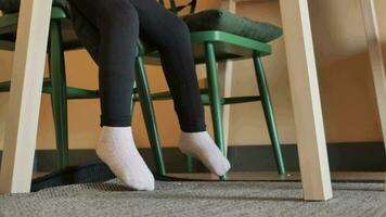 low angle view of 6 year old child girl feet sitting on a chair video