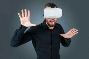 young man using a VR headset glasses photo