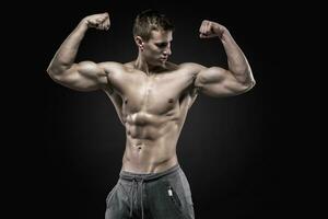 Fitness man model torso posing and showing perfect body photo