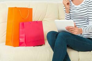 Online shopping. smiling young woman with tablet and credit card photo