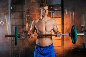 man doing exercises with barbell photo