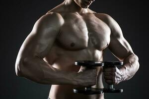 Mighty fitness man showing his gread body with dumbbells photo