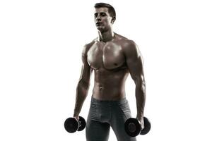 Muscular man showing perfect body with dumbbells, isolated on white photo