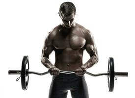 Young handsome man with naked torso and barbell photo