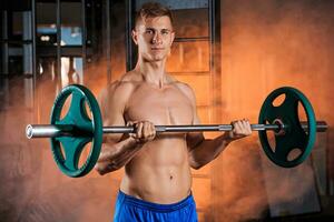 man doing exercises with barbell photo