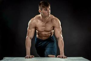 Young Muscular man flipping box photo