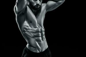 Muscular bodybuilder guy doing posing photo