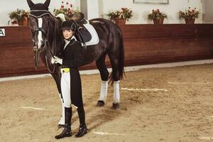 woman jockey with his horse photo