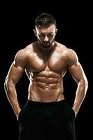 Muscular bodybuilder guy doing posing photo