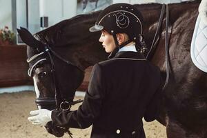 woman jockey with his horse photo