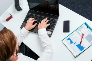 man typing on a laptop keyboard photo