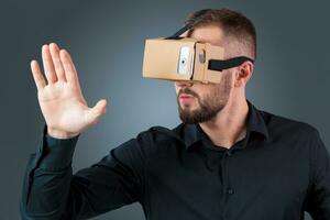 young man using a VR headset glasses photo