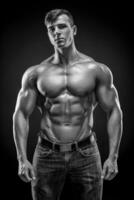 Muscular bodybuilder guy doing posing over black background photo