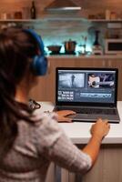 Filmmaker editing video footage in home using modern technology. Content creator in home working on montage of film using modern software for editing late at night. photo