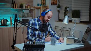 Social media analyst speaking on microphone during podcast in home studio with neon light in the background. Creative online show Onair production internet broadcast host streaming live content, recording digital social media communication photo