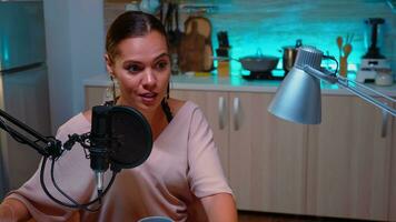 Woman vlogger recording podcast in home studio iluminated with neon light. Creative online show Onair production internet broadcast host streaming live content, recording digital social media communication photo