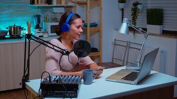 Vlogger looking at laptop while asking her audience to subscribe on her channel. Creative online show Onair production internet broadcast host streaming live content, recording digital social media communication photo