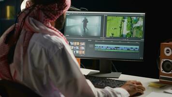 Arabic cinematographer editing new project, creating film montage, working with footage and sound. Man using post production software to process movie on computer workstation photo