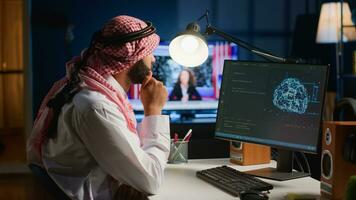 Computer operator updating artificial intelligence neural networks, writing complex binary code scripts. Outsourcing arabic freelancer in personal office uses digital device programming to upgrade AI photo