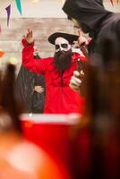 Man dressed up like a party with a big medieval hat celebrating halloween. photo