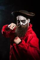 Medieval mariner with beard and hat isolated over black background. Halloween costume. photo