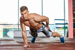 athletic muscular guy doing push-ups photo