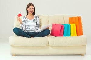 Online shopping. smiling young woman with tablet and credit card photo