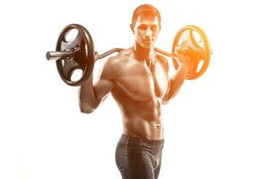 Strong man exercising fitness body building exercises with a barbell photo