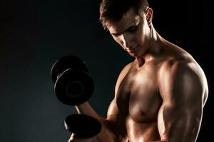 Mighty fitness man showing his gread body with dumbbells photo