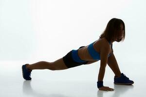 Sporty flexible girl doing stretching exercise photo