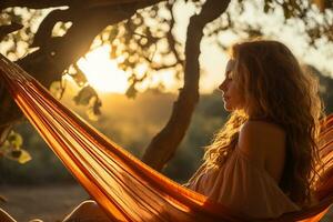 AI generated A beautiful girl with luxurious hair sits in a hammock stretched between two trees in nature, in the rays of the warm sun photo