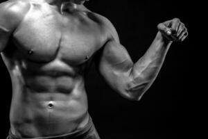 Close-up of man flexing showing his triceps, biceps muscles photo