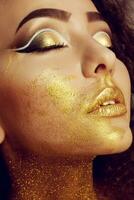 Magic Girl Portrait in Gold. Golden Makeup photo