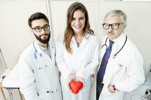 group of doctors with a symbol heart in their hands photo