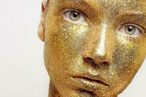 Magic Girl Portrait in Gold. Golden Makeup photo