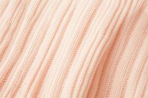 AI generated soft knitted sweater fabric in color of the year 2024 peach fuzz photo