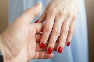 Female hands stroking man's hands. photo