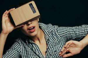 Color shot of a young woman looking through cardboard photo